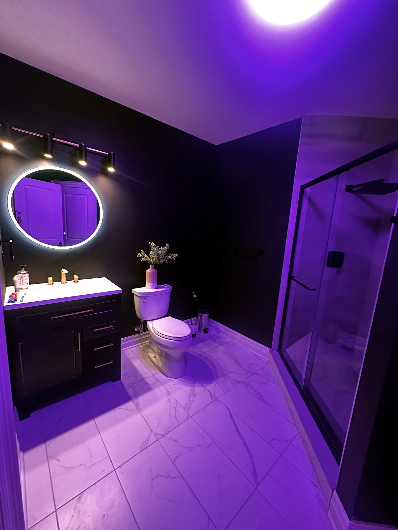 Renovated bathroom with purple mood lighting